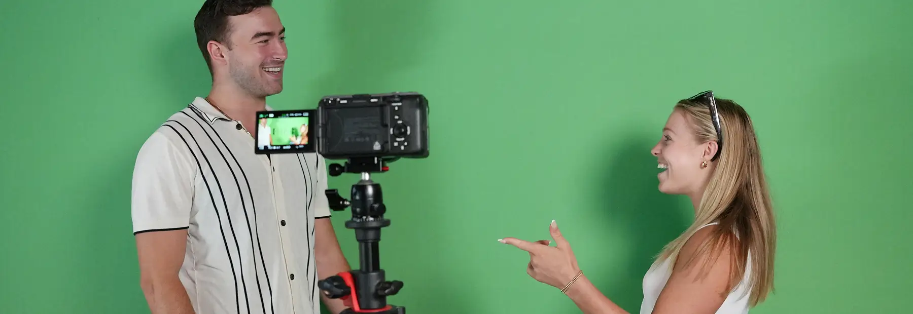 man and women in front of a green screen
