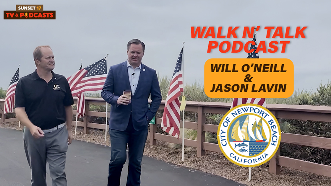 Will O'Neill and Jason Lavin walking along a flag-lined path in Newport Beach for the Walk N' Talk Podcast