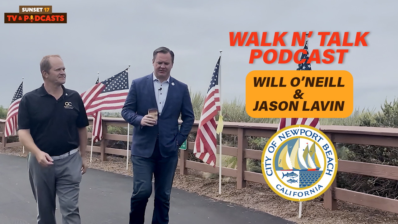 Jason Lavin and former Newport Beach Mayor Will O’Neill walking past rows of American flags at the Field of Honor in Castaways Park.